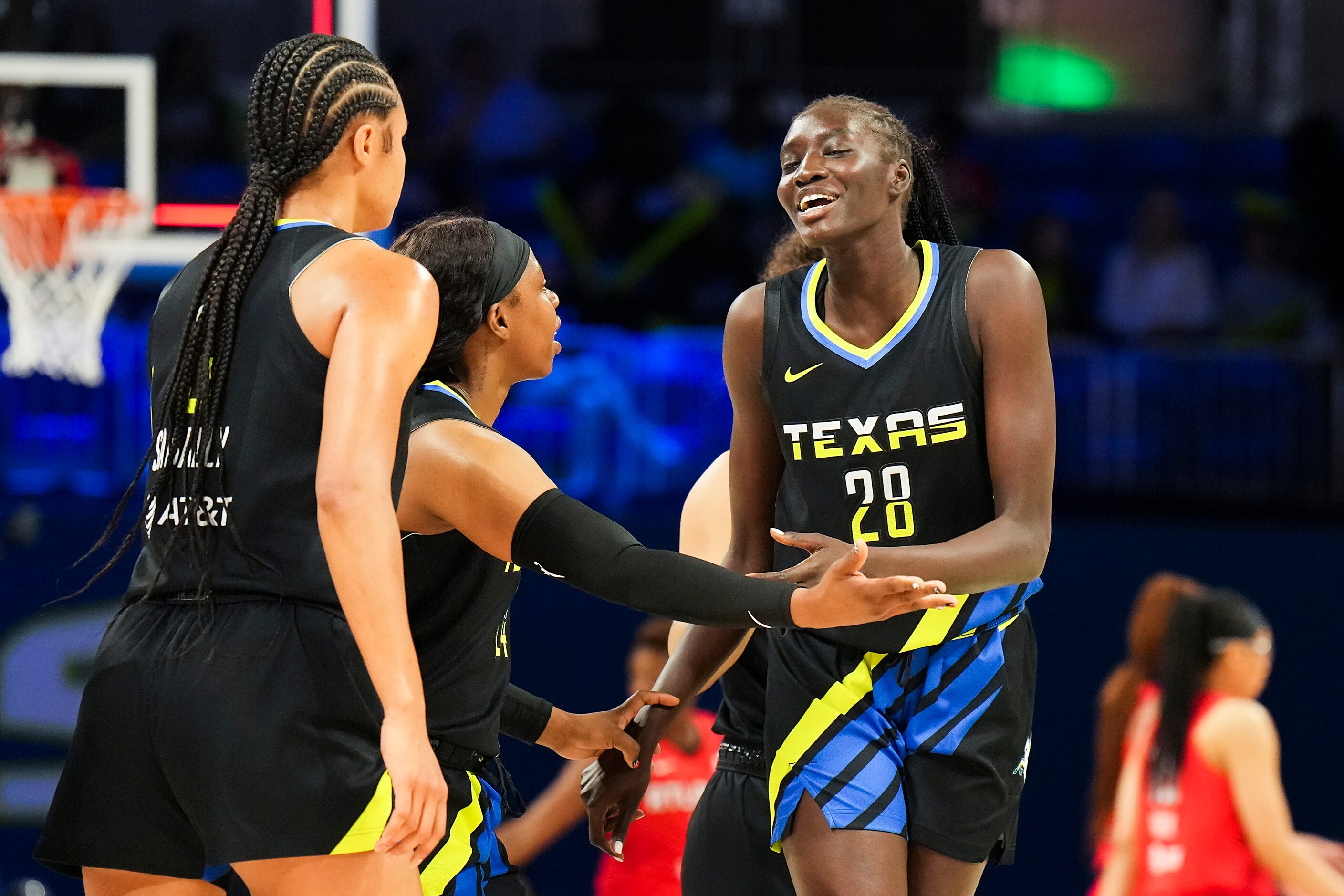 Dallas Wings forward Awak Kuier (28) celebrates with guard Arike Ogunbowale (24) during the...