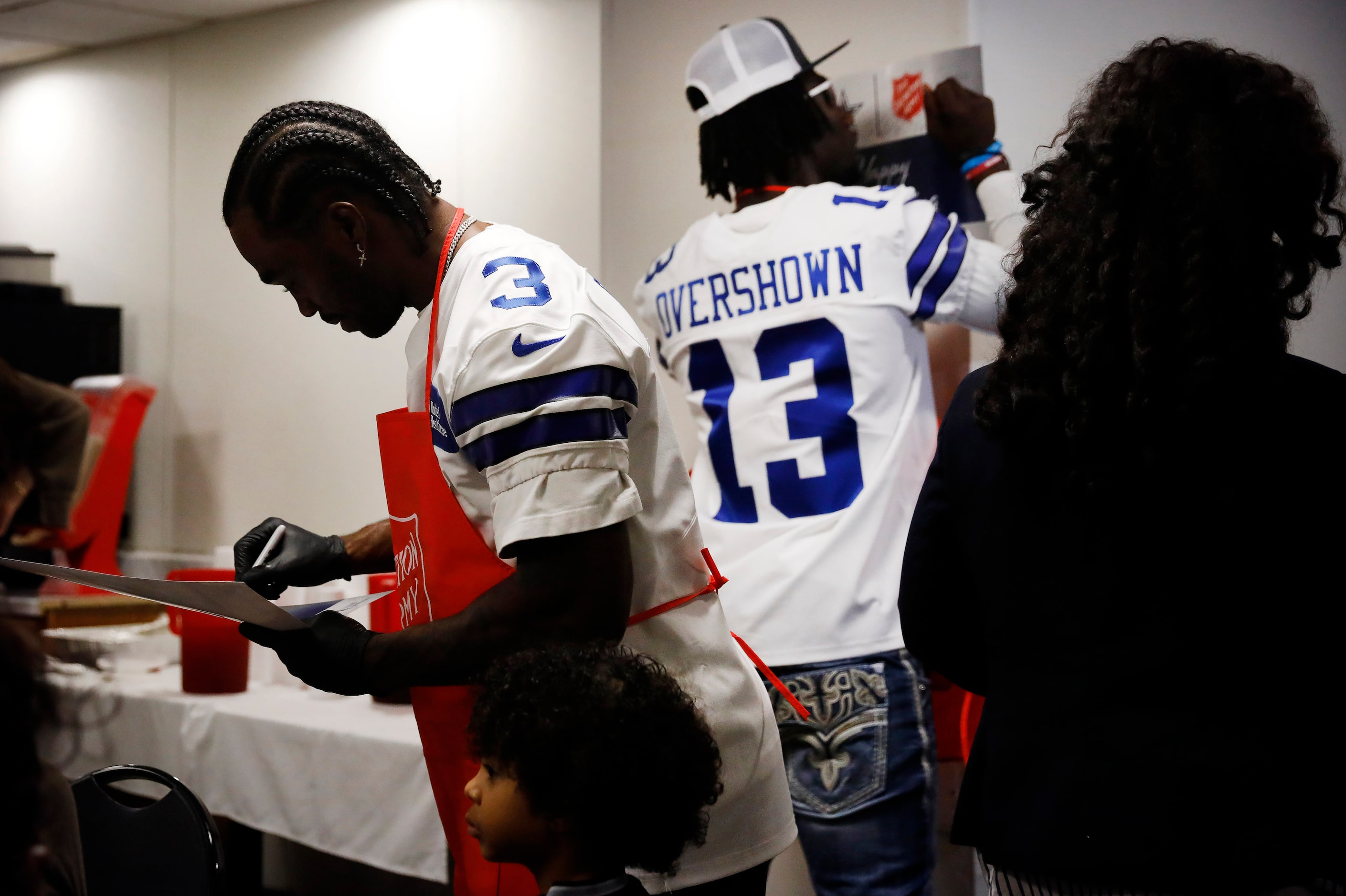 Dallas Cowboys wide receiver Brandin Cooks (3) and linebacker DeMarvion Overshown (13) signs...