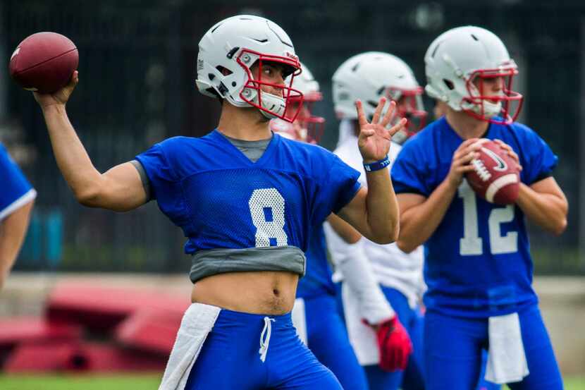 Quarterback Ben Hicks (8) throws a pass during SMU's first football practice of the season...