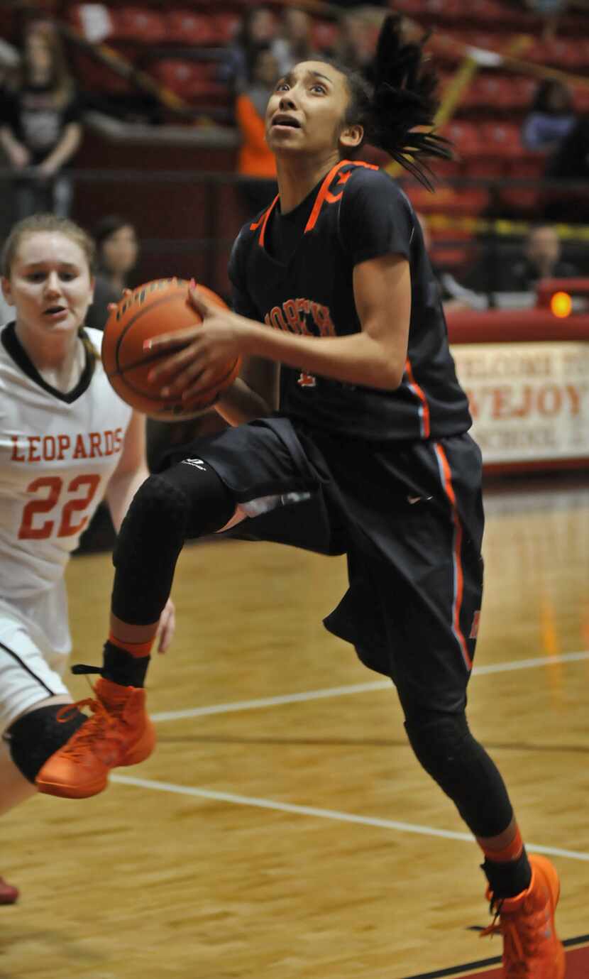 McKinney North freshman Stephanie Jackson (15) muscles through a foul from Lovejoy junior...