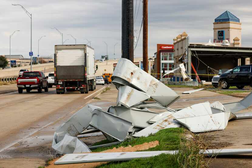 Large pieces of metal are seen wrapped around an electrical pole after a possible tornado in...