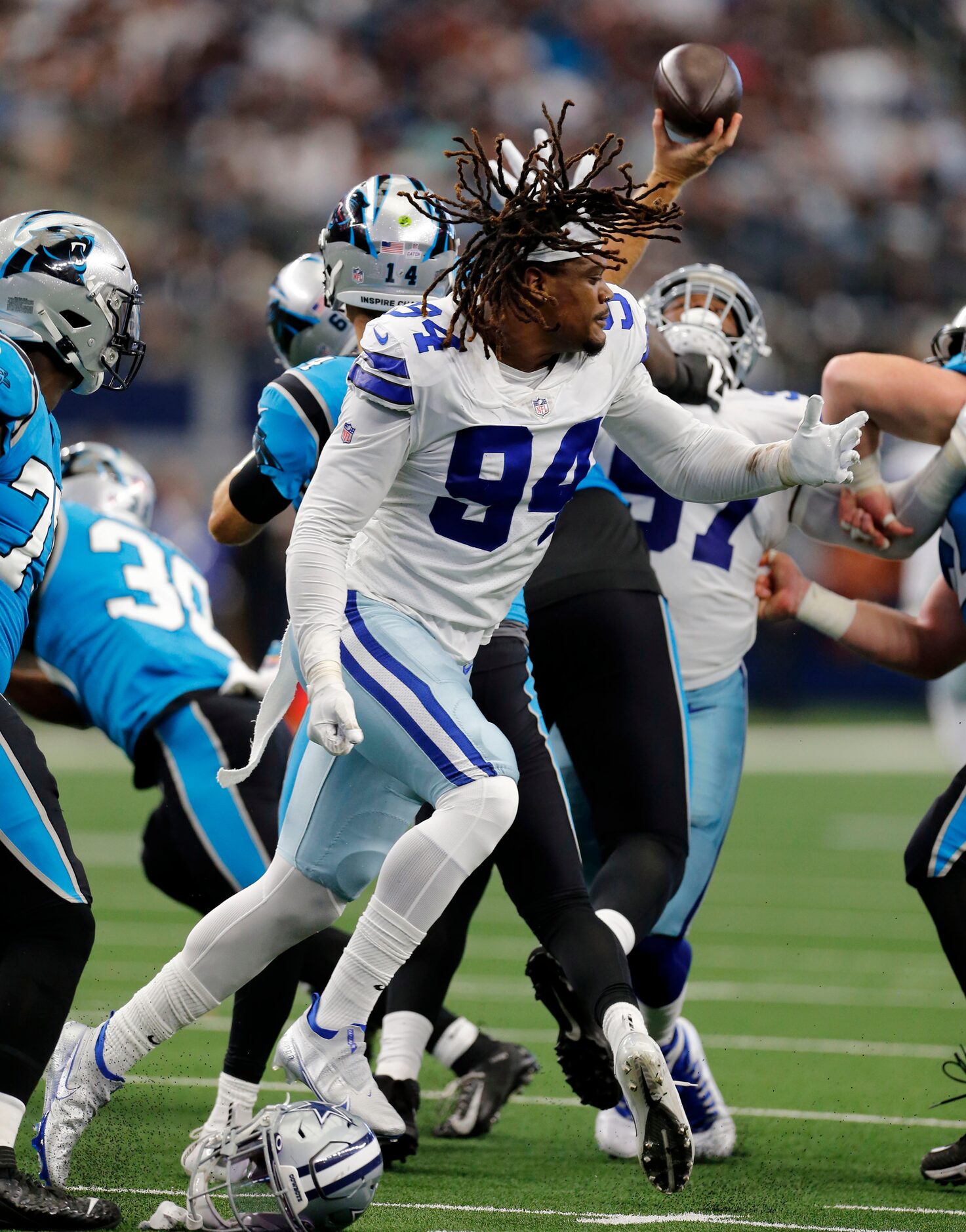 Dallas Cowboys defensive end Randy Gregory (94) has his helmet ripped off, as he rushes...