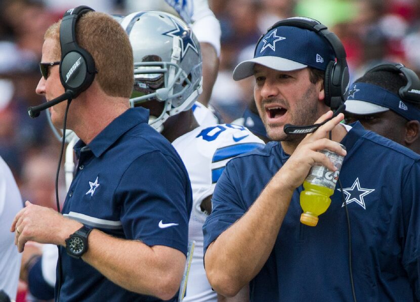 Dallas Cowboys quarterback Tony Romo yells toward head coach Jason Garrett on the sidelines...