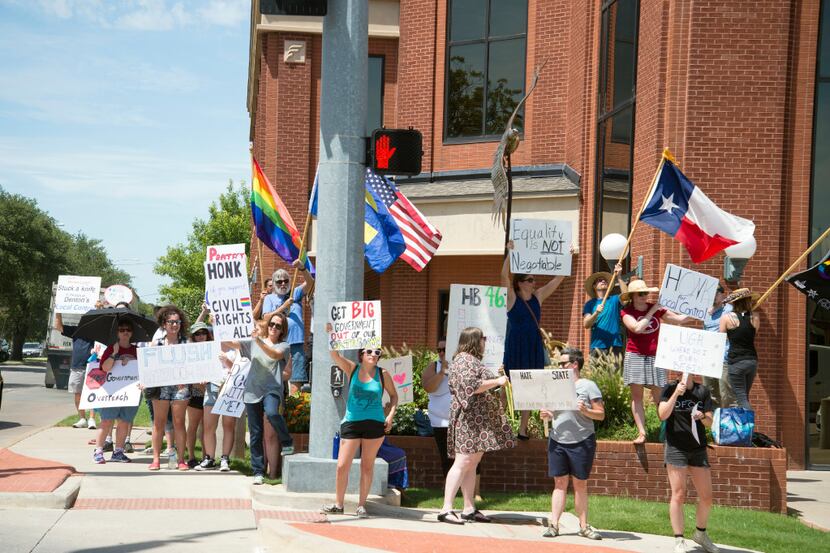 Protesters gathered outside state Rep. Lynn Stucky's office in Denton on July 28 to protest...