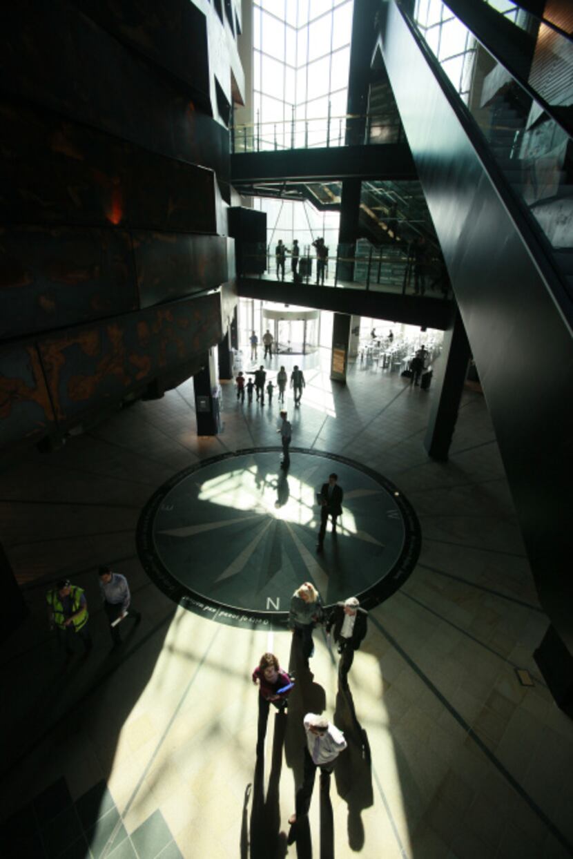 People walk in the main reception area in the Titanic Belfast visitor centre in Belfast,...