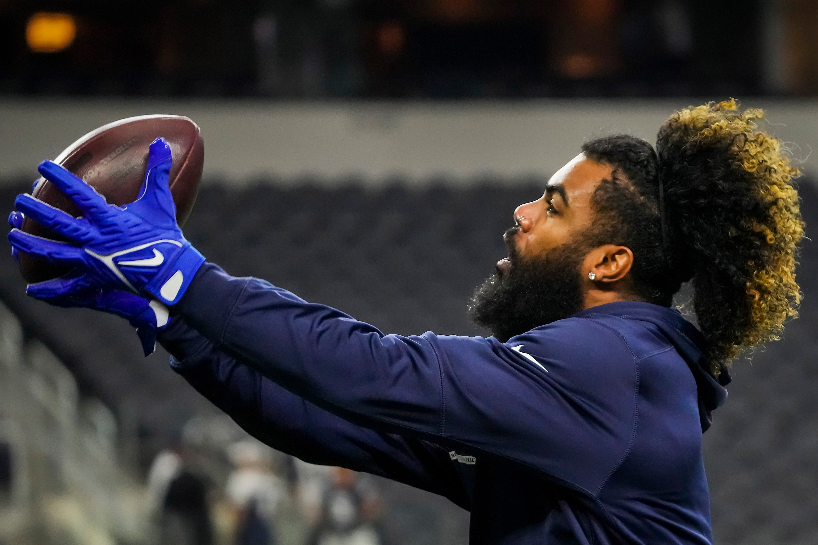 Dallas Cowboys running back Ezekiel Elliott catches a pass as the team warms up before a...