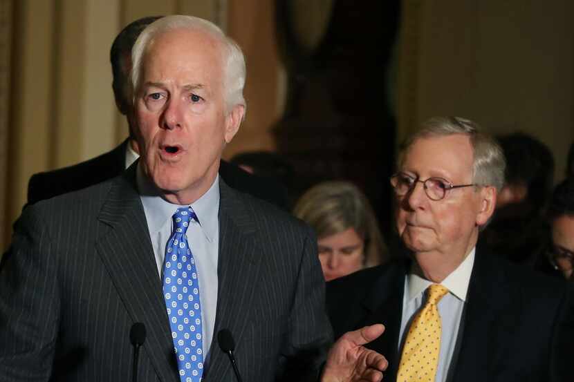 Sen. John Cornyn (R-TX) speaks to reporters while flanked by Senate Majority Leader Mitch...