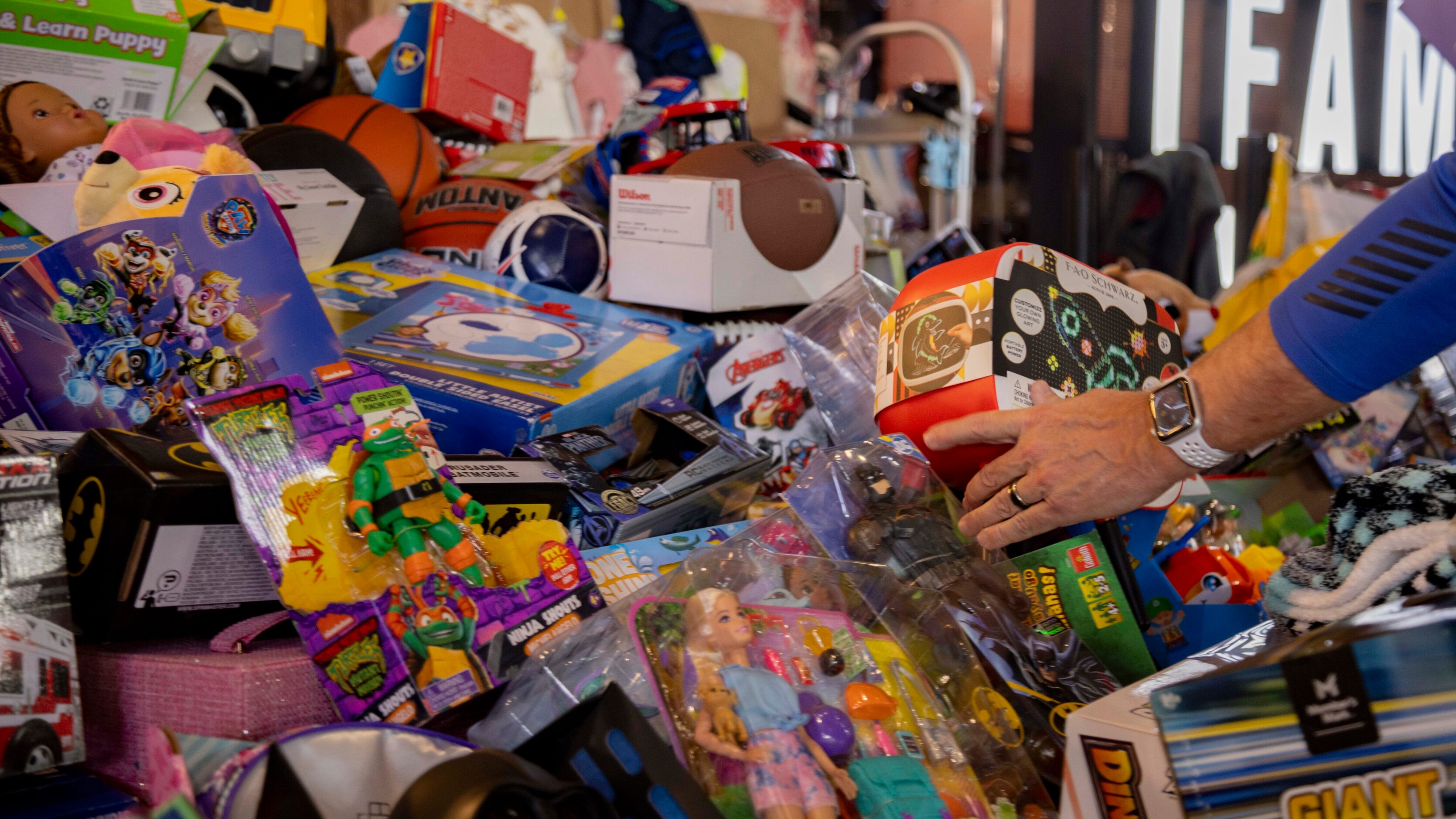 Toys are placed in a pile during the Texas Rangers Toy Drive at Globe Life Field in...