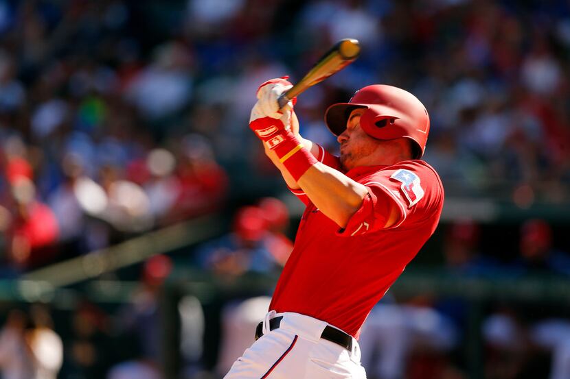 Texas Rangers third baseman Patrick Wisdom (21) takes a big cut on a Houston Astros pitch at...