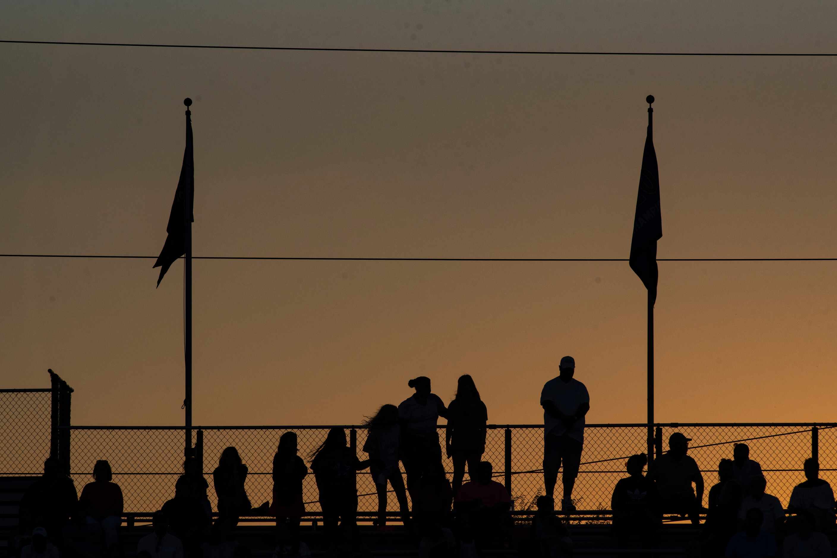 Fans watch from the stands as the sun sets during Parish EpiscopalÕs home game against...