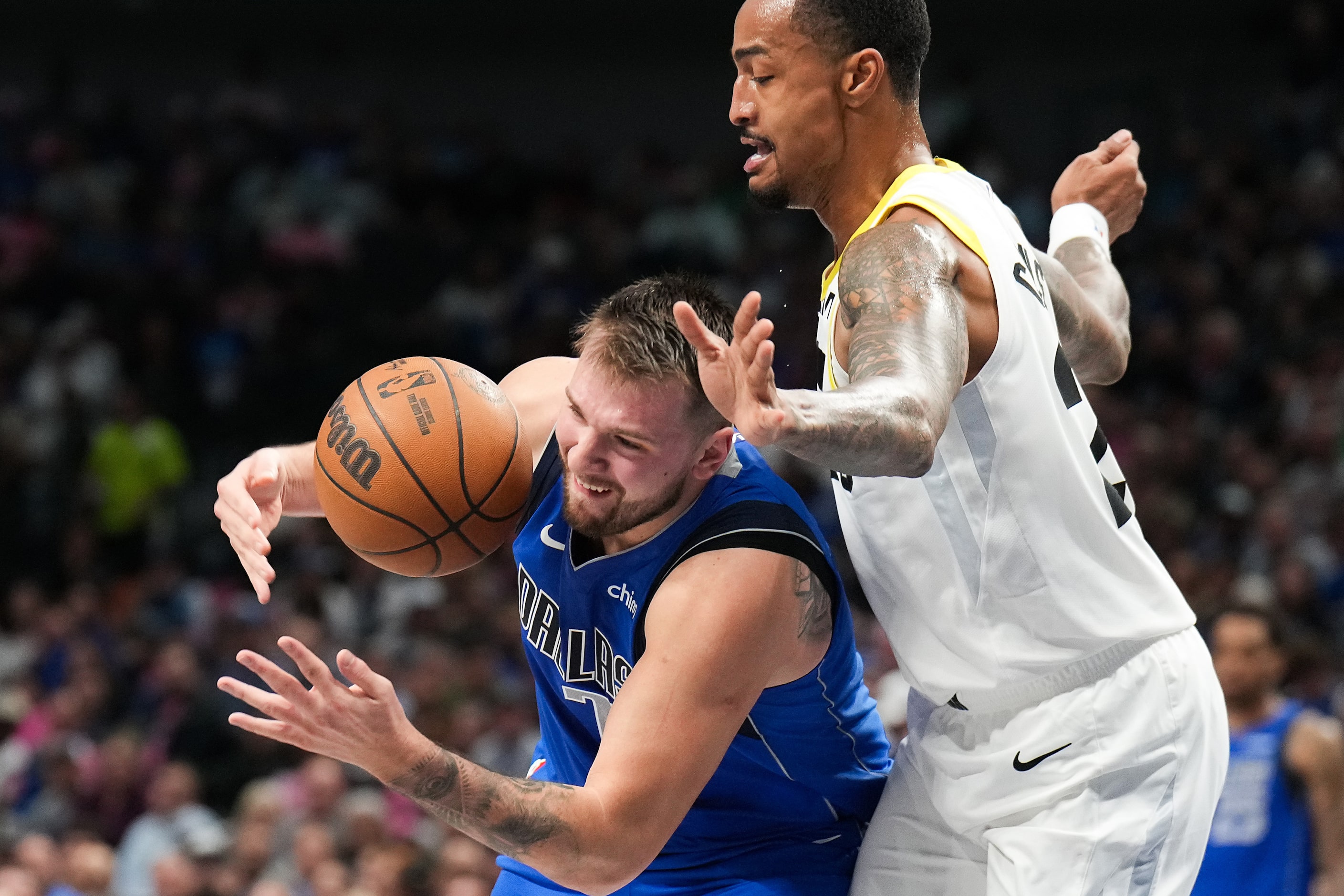 Dallas Mavericks guard Luka Doncic (77) is fouled by Utah Jazz forward John Collins (20)...