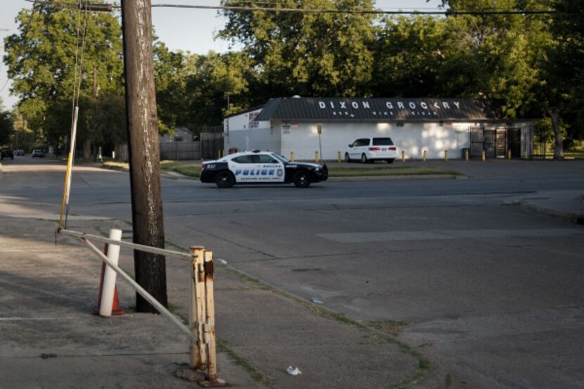 On Wednesday, a Dallas police cruiser patrolled Dixon Avenue in front of Dixon Grocery, the...