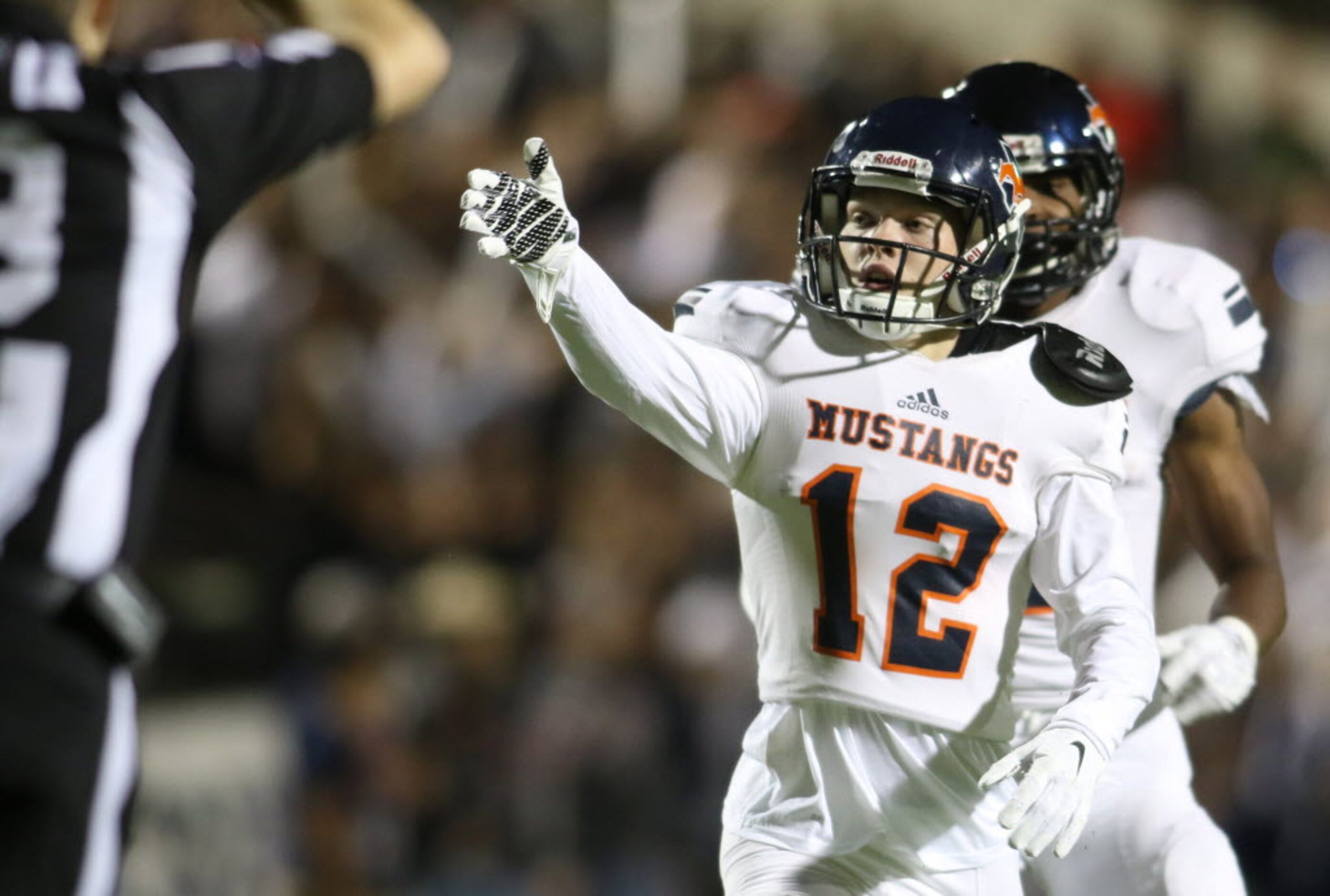 Sachse receiver Nate Shelton (12) signals for a first down following his long pass reception...