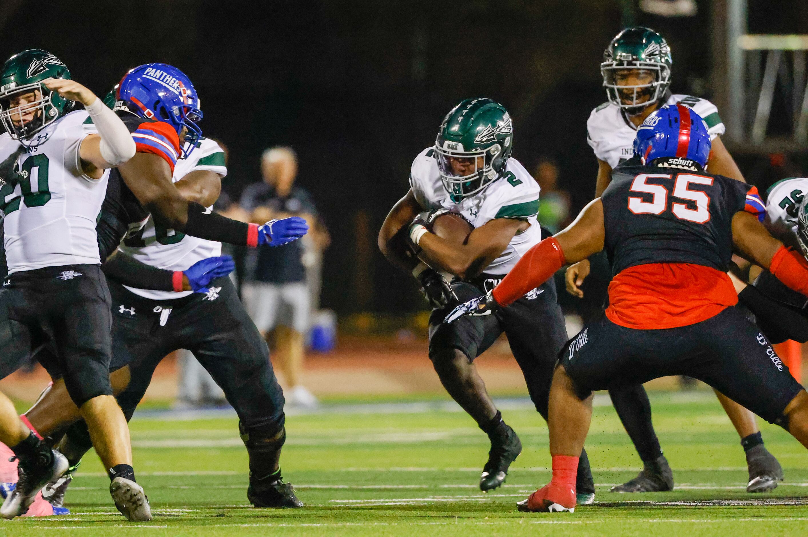 Waxahachie running back Iverson Young (2) runs toward a gap in Duncanville defense in the...