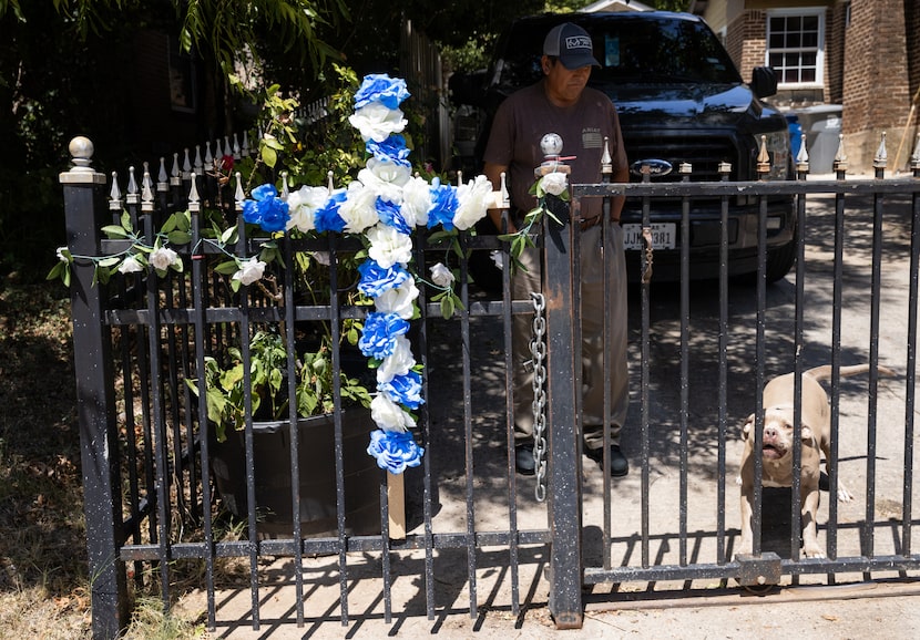 Francisco Villegas looks at his son Juan Carlos Villegas’s dog, Diamond, beside a blue and...