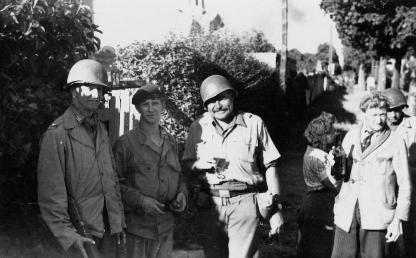 Ernest Hemingway and Col. David K.E. Bruce of the OSS, with a member of the French...