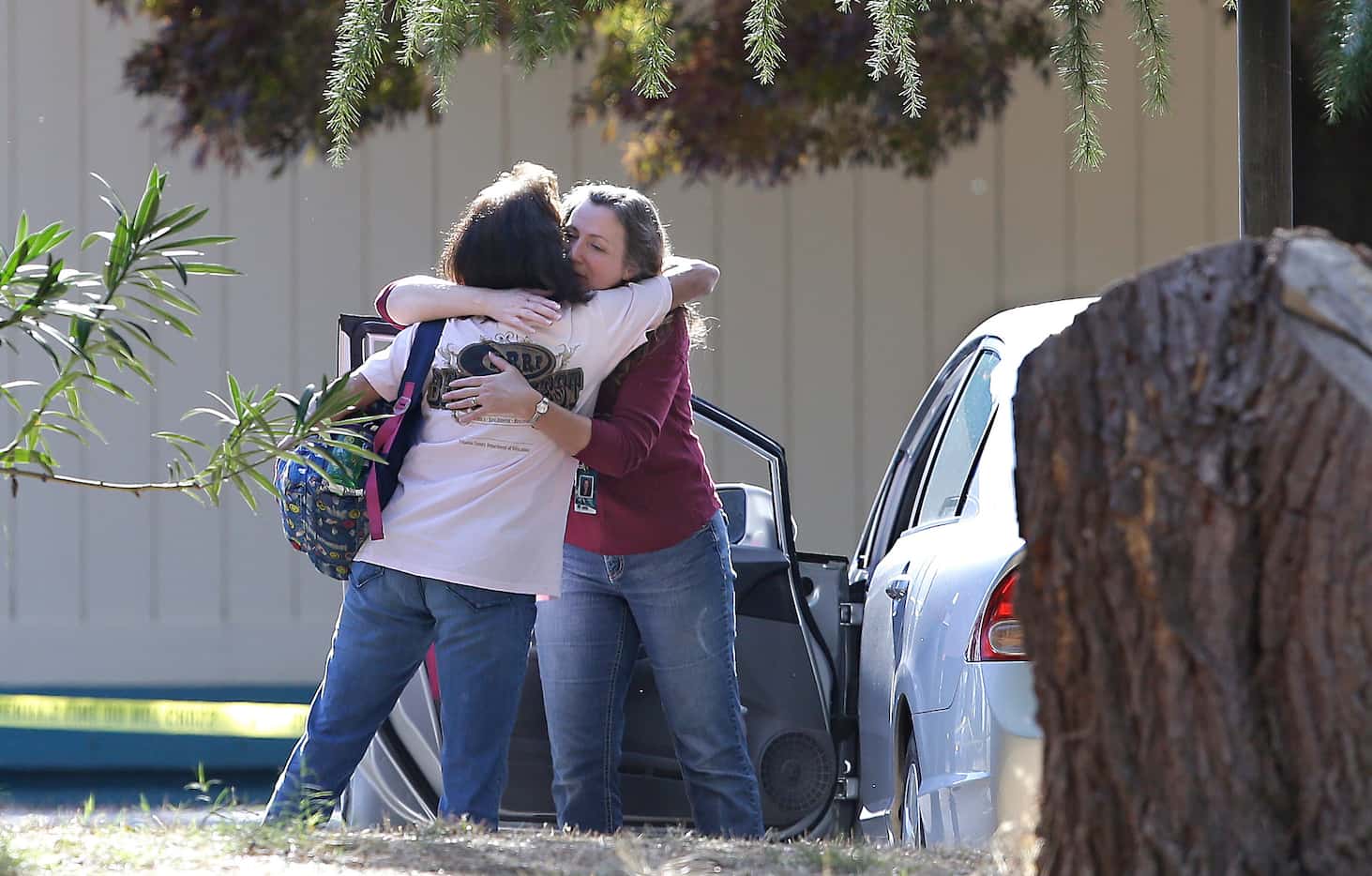 Two women embrace outside Rancho Tehama Elementary School, where a gunman opened fire...