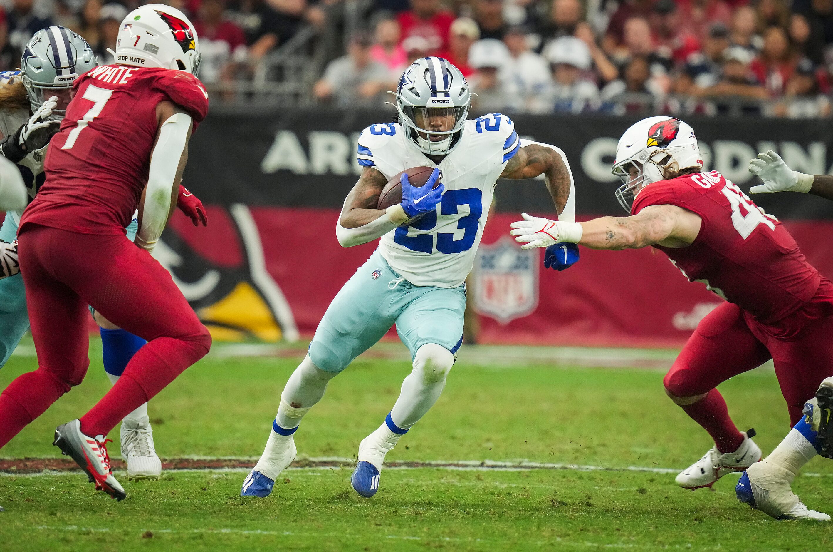 Dallas Cowboys running back Rico Dowdle (23) runs between Arizona Cardinals linebacker...