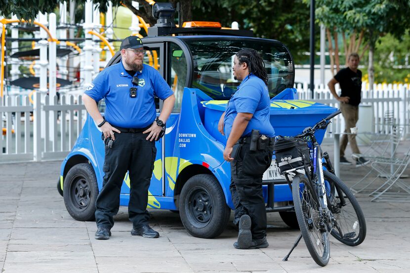 Sgts. Ryan Peterson (left) and Tim Walker of Downtown Dallas Inc. security talk Tuesday at...