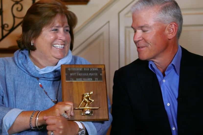 Mary Templeton brandishes her high school ski team MVP award to her husband, Rich, Texas...