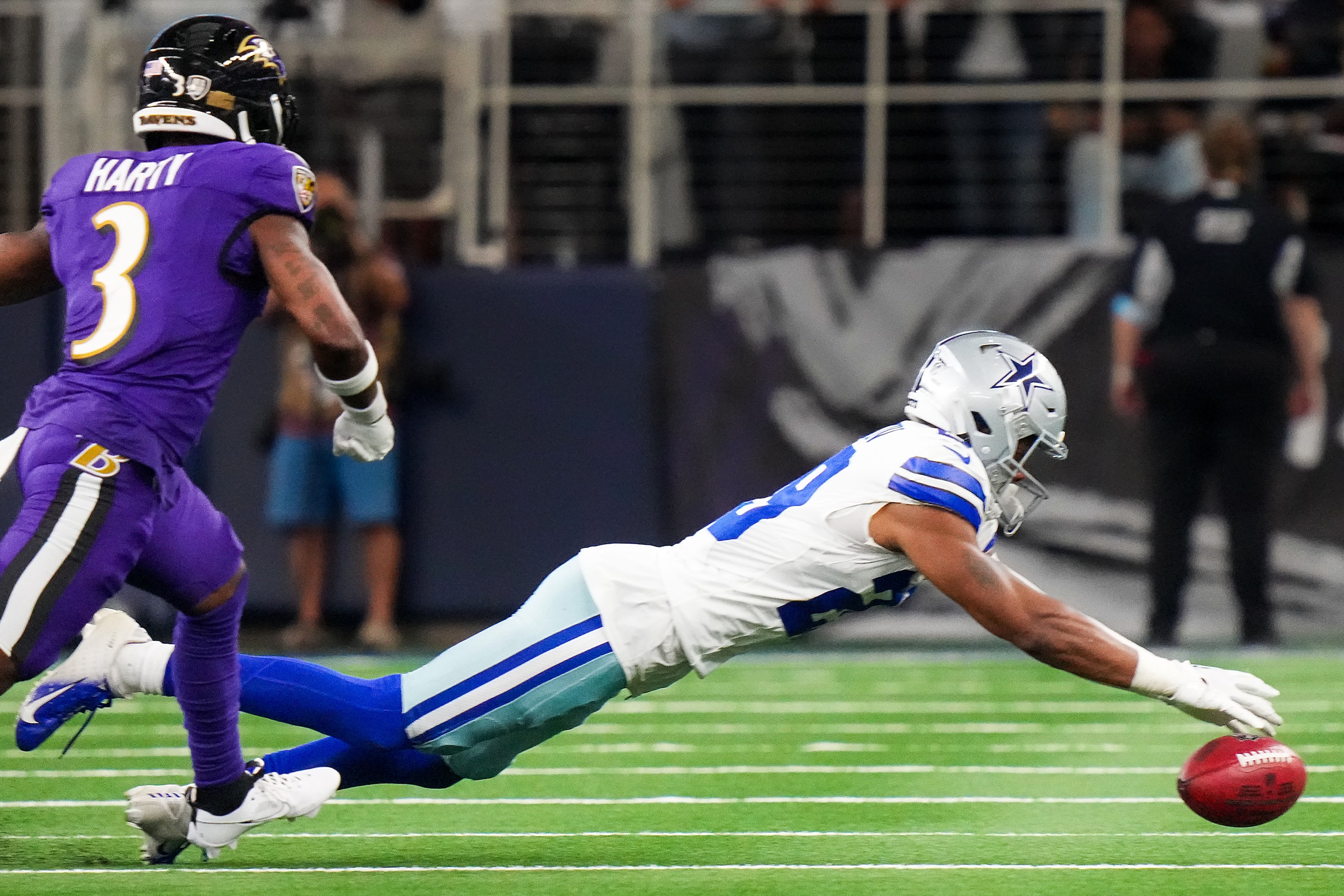 Dallas Cowboys cornerback C.J. Goodwin (29) recovers an onside kick past Baltimore Ravens...