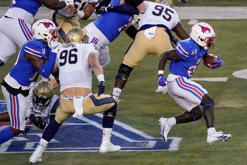 SMU running back Ulysses Bentley IV (26) gets past Navy defensive tackle Jackson Perkins...