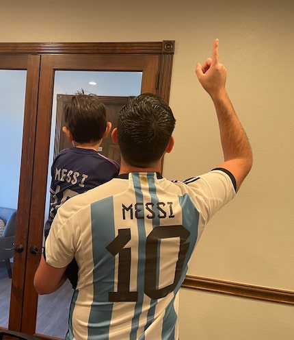 Mauro Ahumada and his son Lionel Agustín wear their Argentina national team jerseys in...