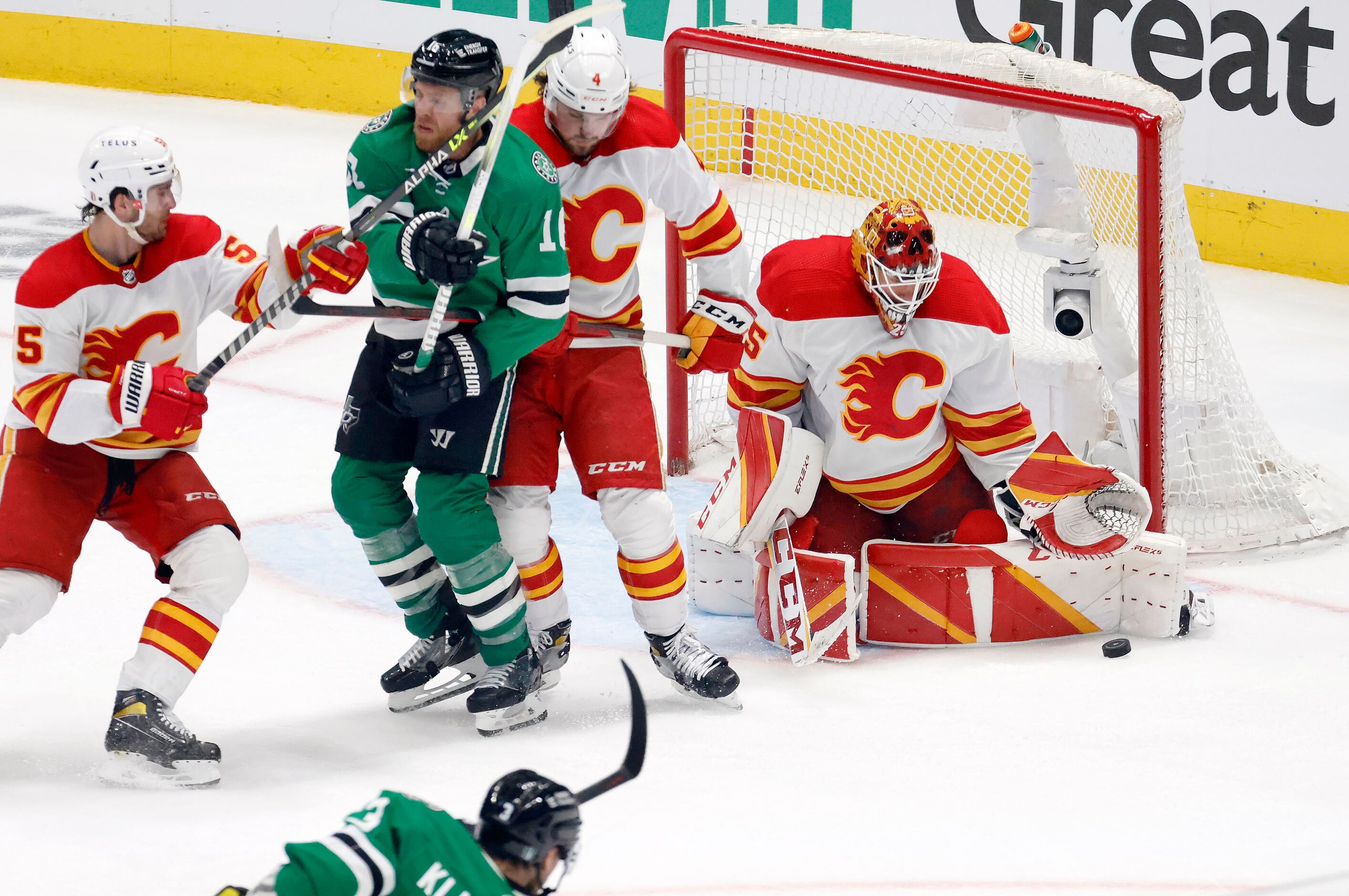 Calgary Flames goaltender Jacob Markstrom (25) deflects a shot on gaol by Dallas Stars...