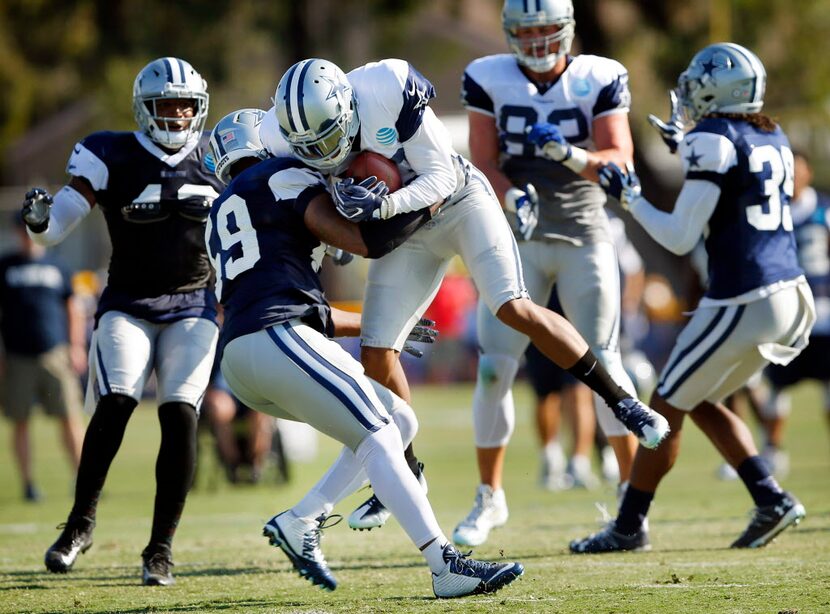 Dallas Cowboys wide receiver Terrance Williams (83) plows into middle linebacker Anthony...