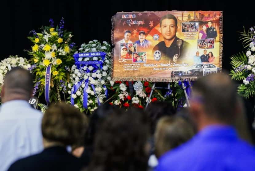 Photos are displayed during a funeral service for Dallas police officer Patrick Zamarripa on...