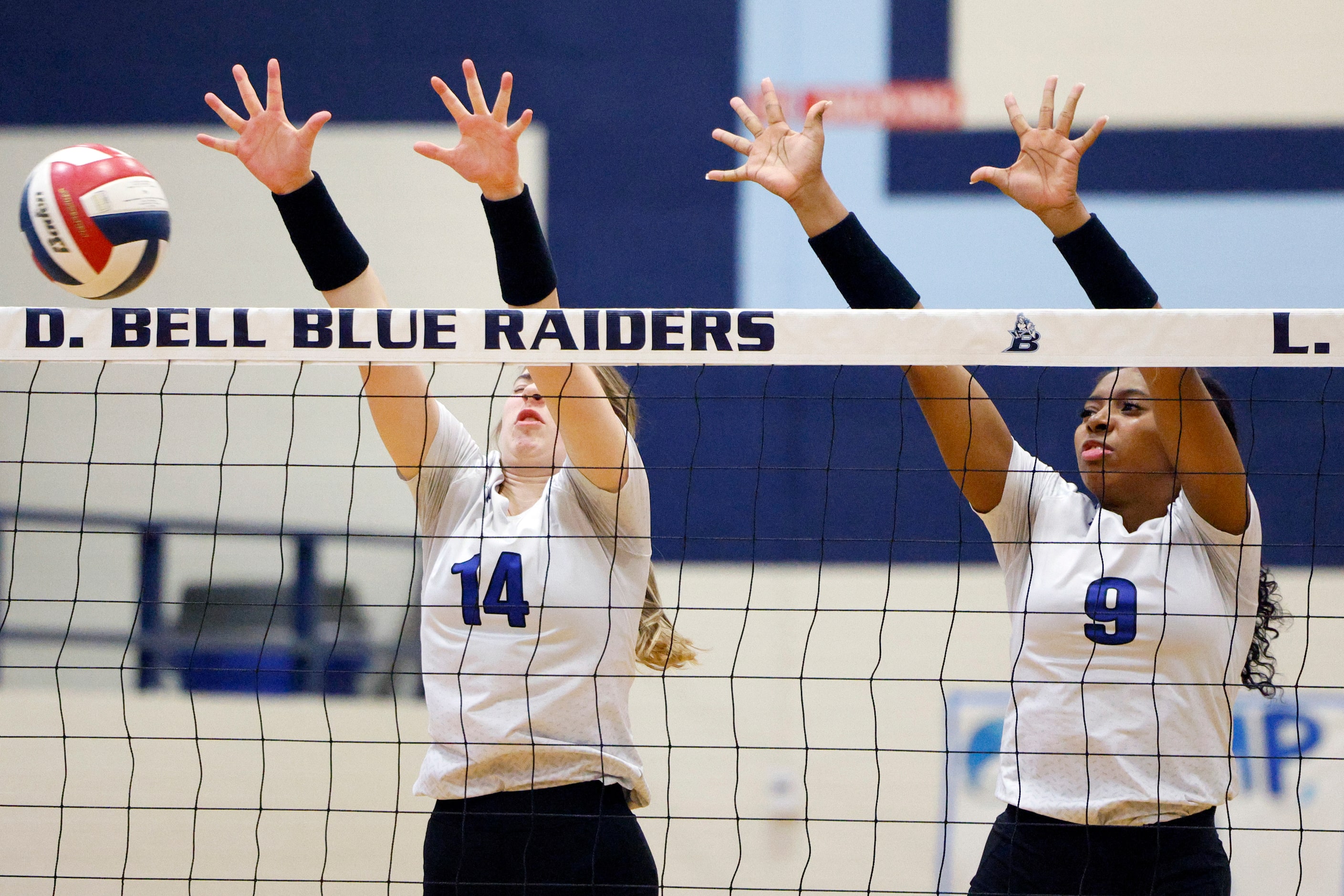 Trophy Club Byron Nelson's Lexi Proctor (14) and Zion Coates (9) jump to block a shot during...