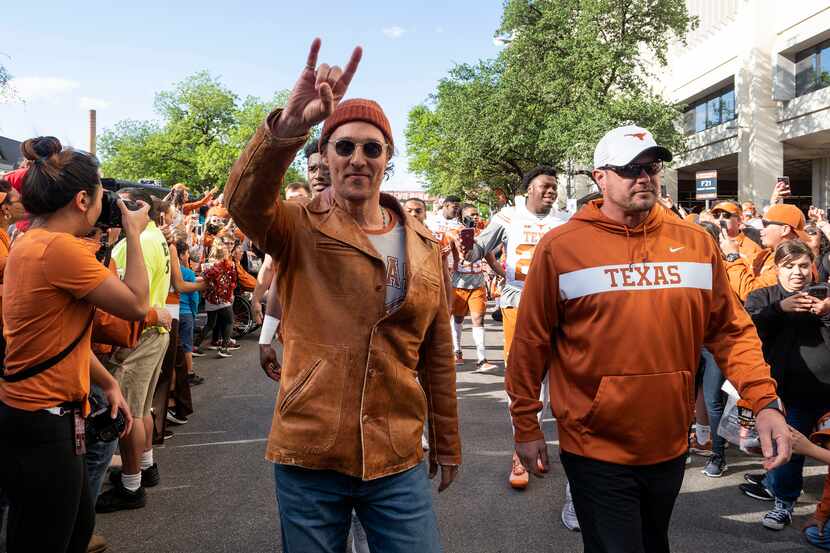 Actor Matthew McConaughey (left) and University of Texas football coach Tom Herman marched...