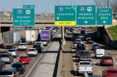 Semitrucks drove slowly in traffic along Interstate 30 near the exit for Interstate 45 and...