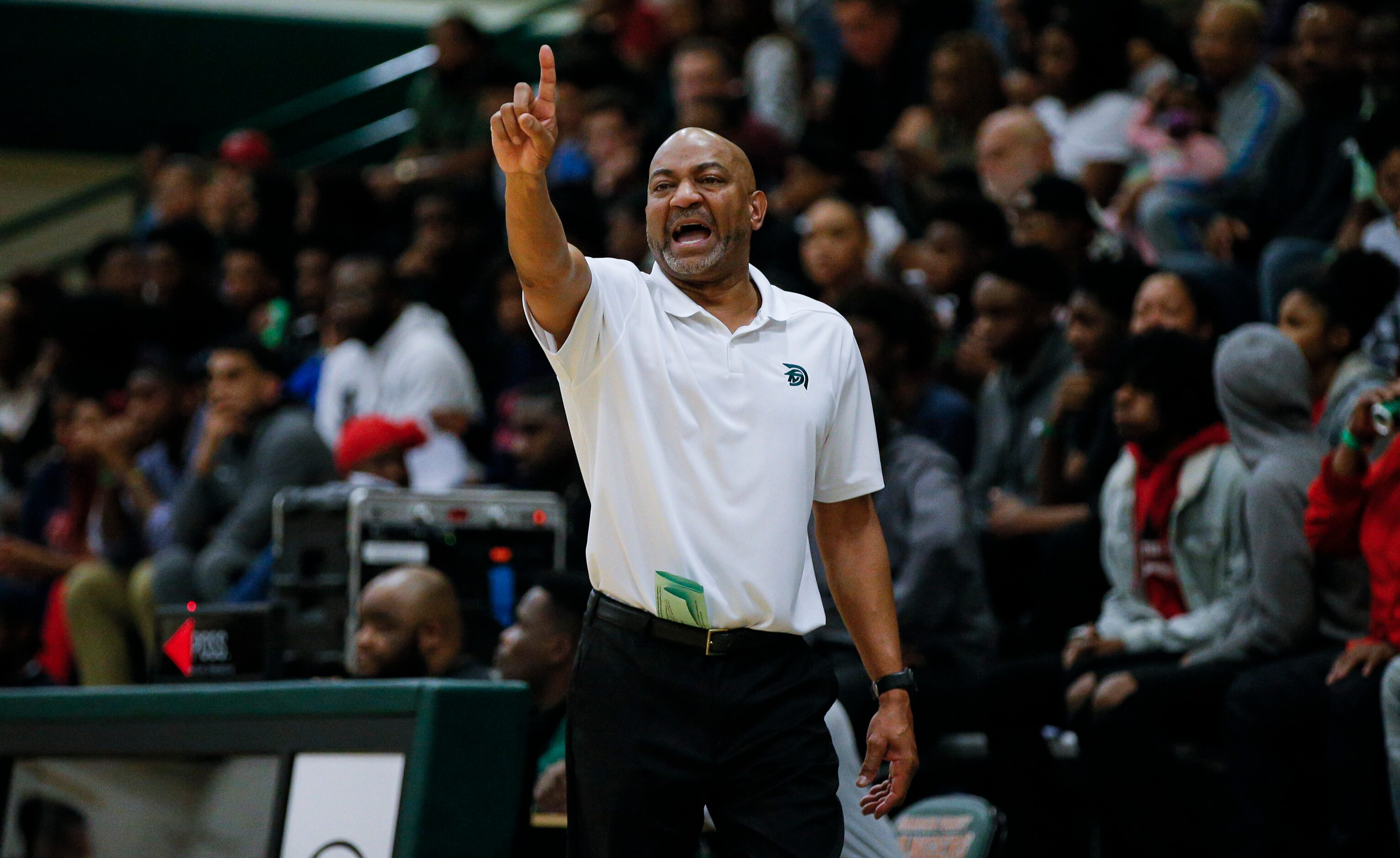 Newman Smith head coach Percy Johnson signals to his players during the second half of a...