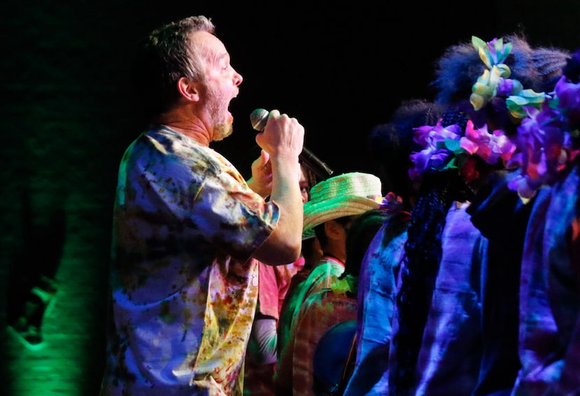 Children's singer and songwriter Eddie Coker, of Dallas, performs with campers in a...