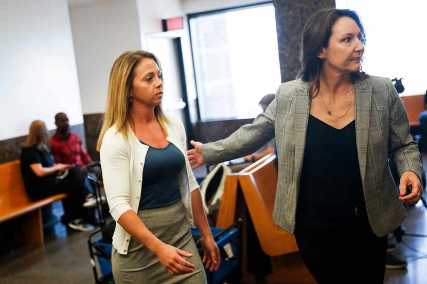 Former Dallas police Officer Amber Guyger (left) enters the 204th District Court in the...