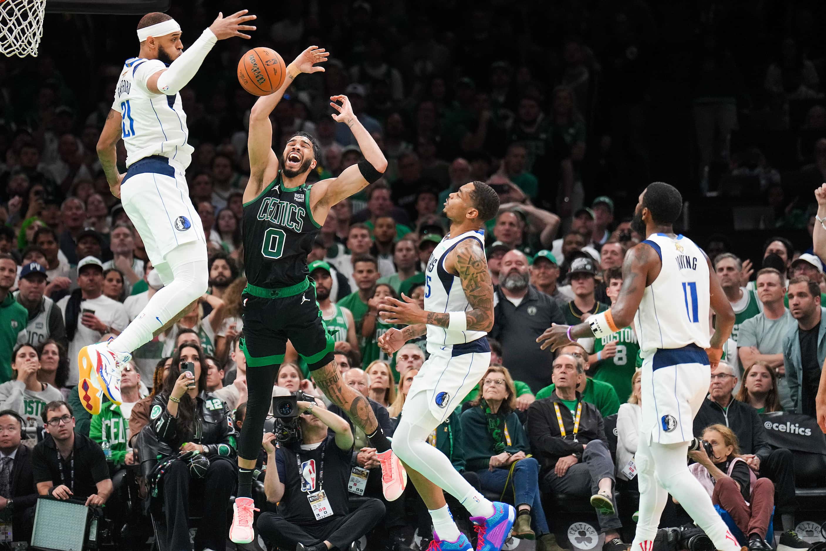Boston Celtics forward Jayson Tatum (0) loses the ball as Dallas Mavericks center Daniel...