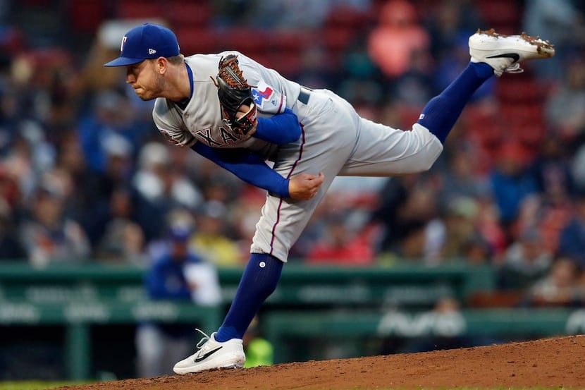 Texas Rangers' Adrian Sampson pitches during the first inning of a baseball game against the...