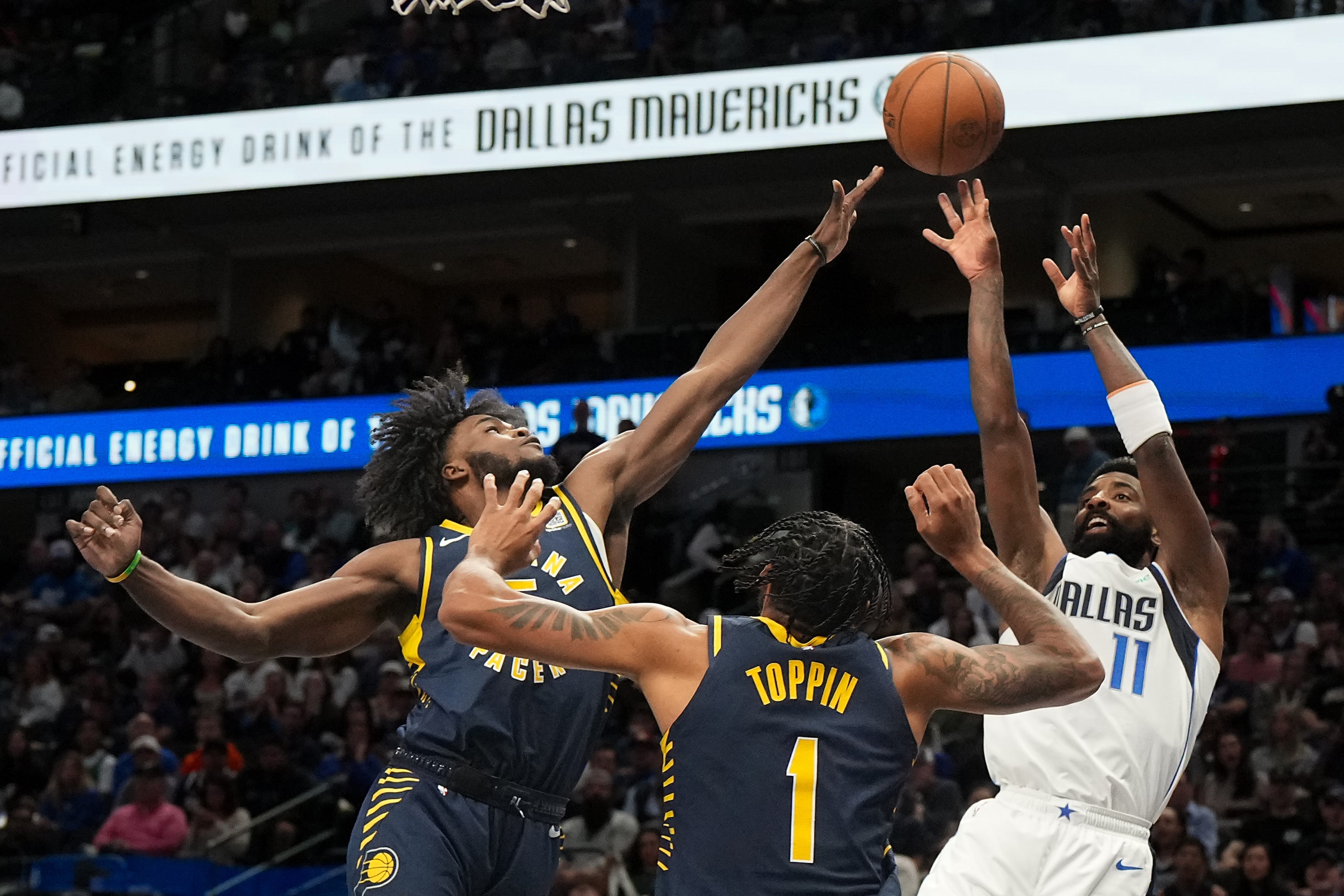 Dallas Mavericks guard Kyrie Irving (11) shoots over Indiana Pacers forward Obi Toppin (1)...