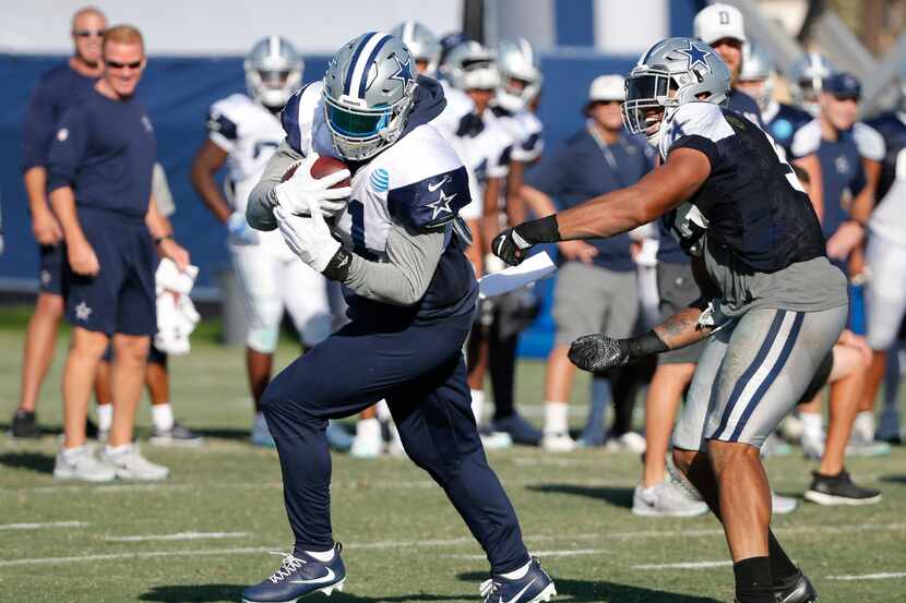 Dallas Cowboys running back Ezekiel Elliott (21) spins away from Dallas Cowboys outside...