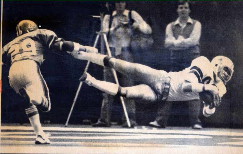 January 15, 1978 - Butch Johnson makes a diving catch at the goal line and falls into the...