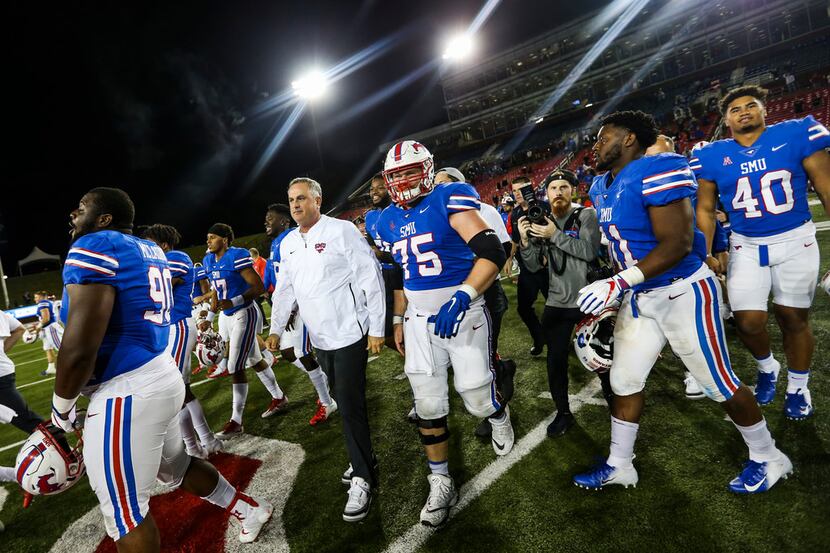 Southern Methodist Mustangs head coach Sonny Dykes makes his way onto the field following a...