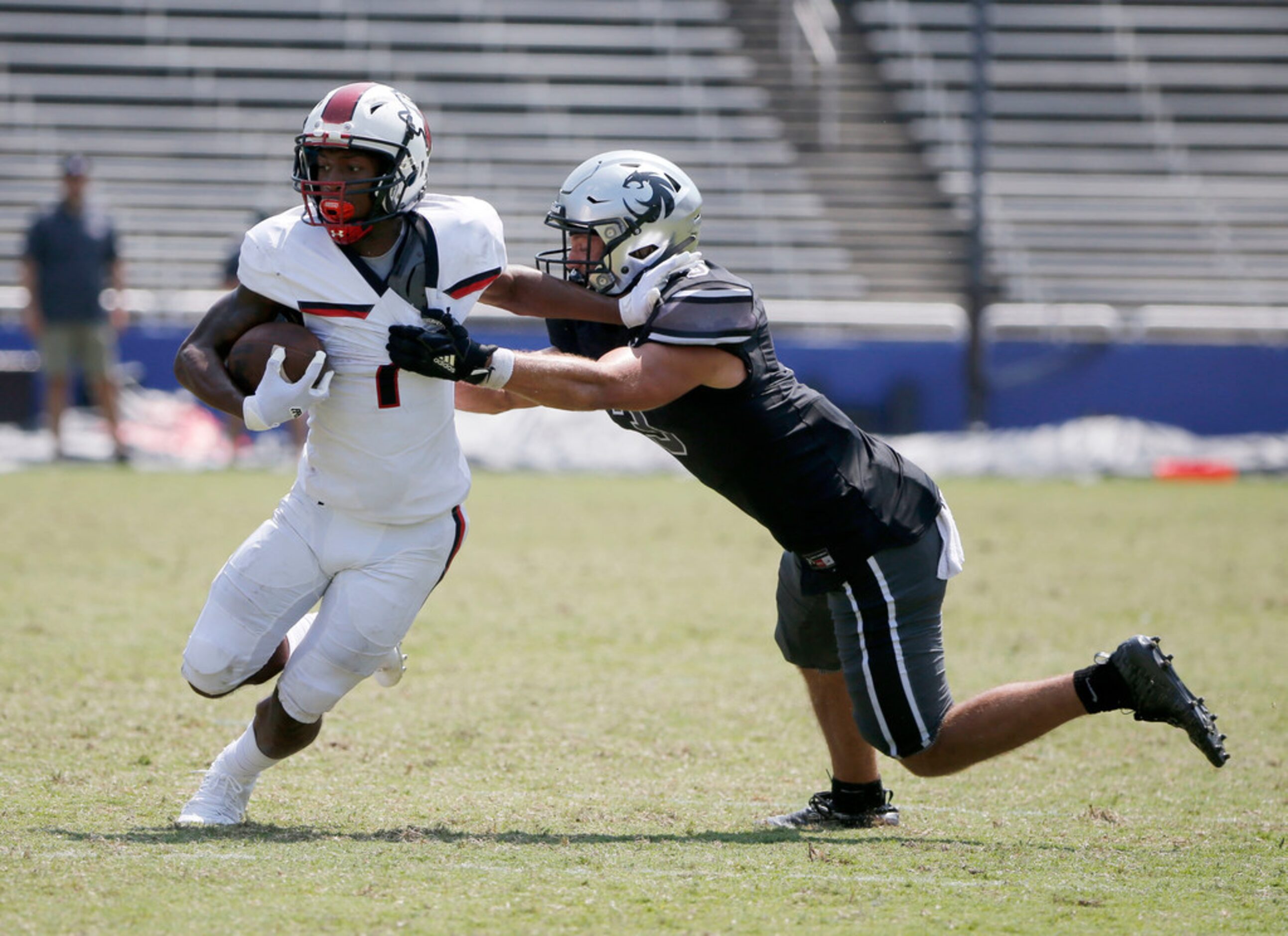 Cedar Hill's Quin Bright (1) is tackled by Denton Guyer defender Trace Jewell (3) during the...