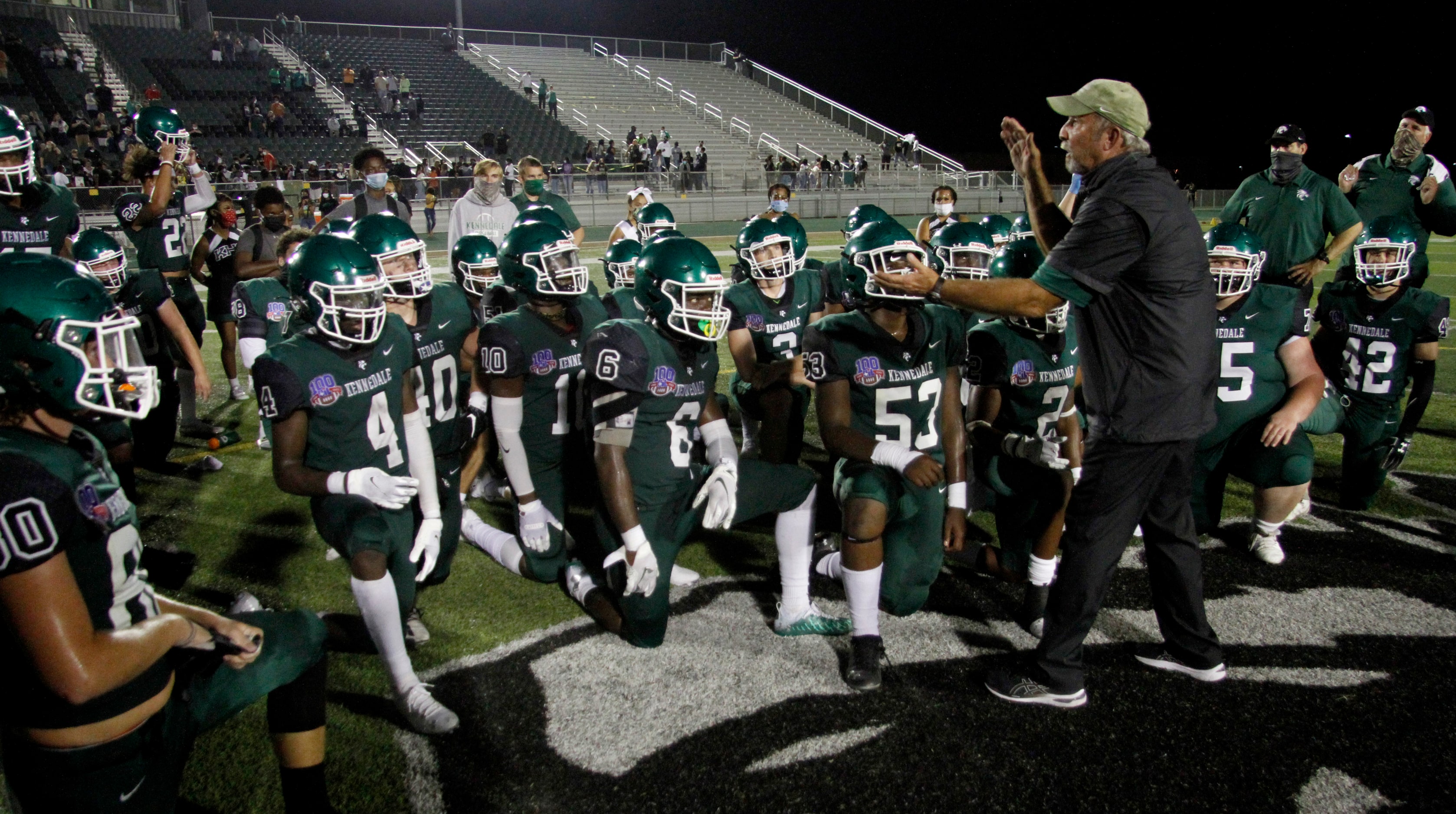 Kennedale head coach Richard Barrett speaks with his players following the Wildcats' 28-27...