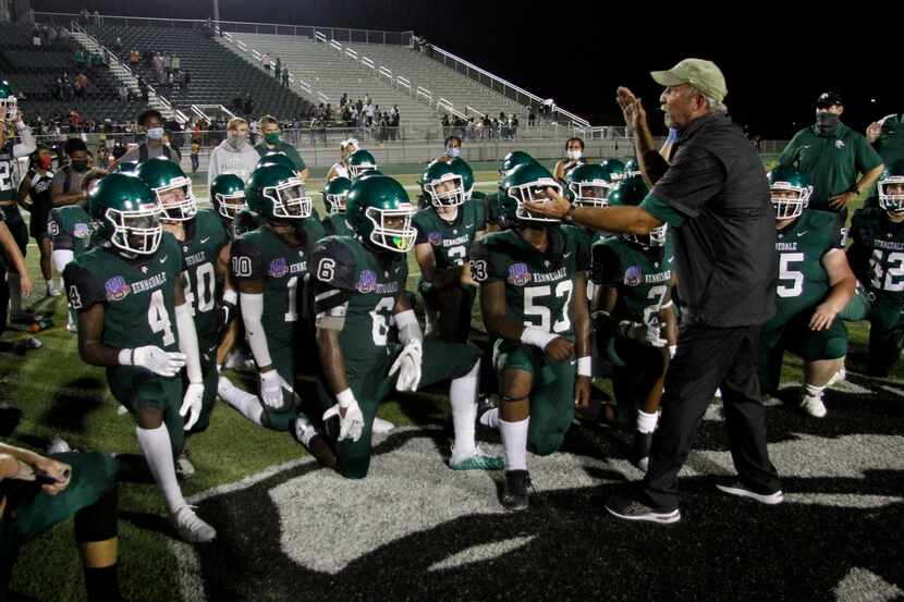 Kennedale coach Richard Barrett speaks with his players following the Wildcats' 28-27...