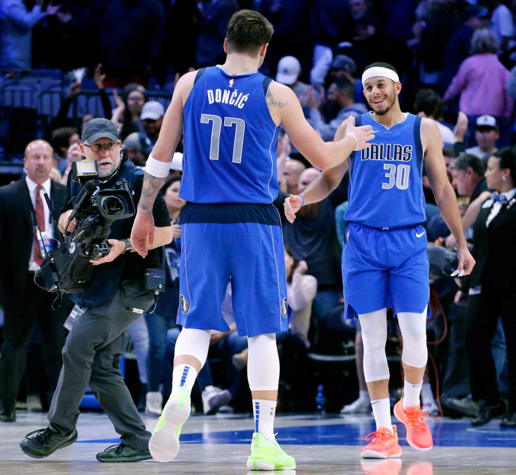 Dallas Mavericks guard Seth Curry (30) congratulates forward Luka Doncic (77) on their win...