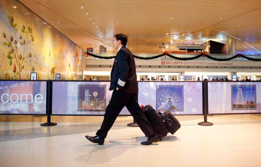 A Southwest Airlines pilot arrives for work at Dallas Love Field on Wednesday.