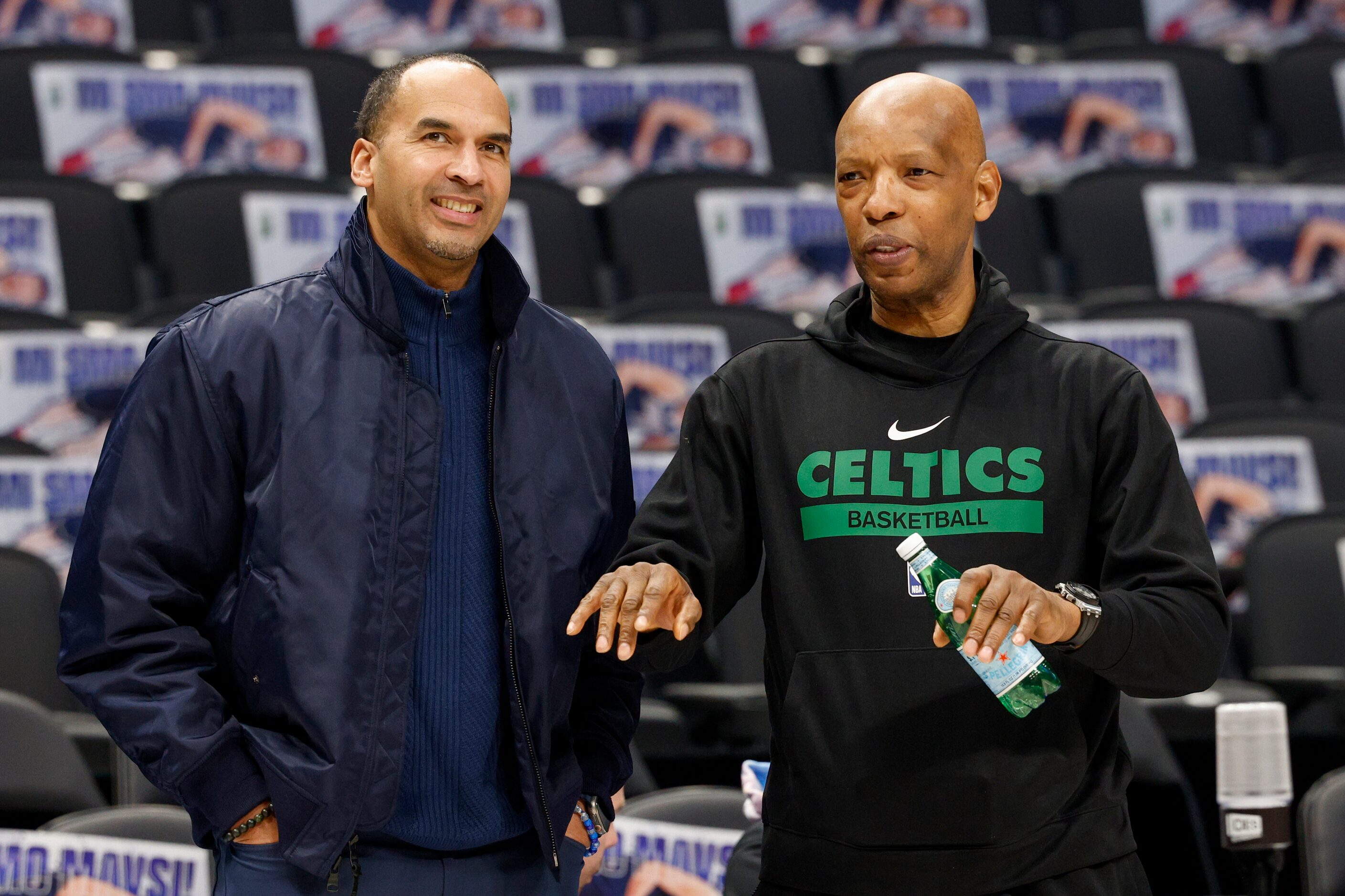 Dallas Mavericks general manager Nico Harrison (left) talks with Boston Celtics assistant...