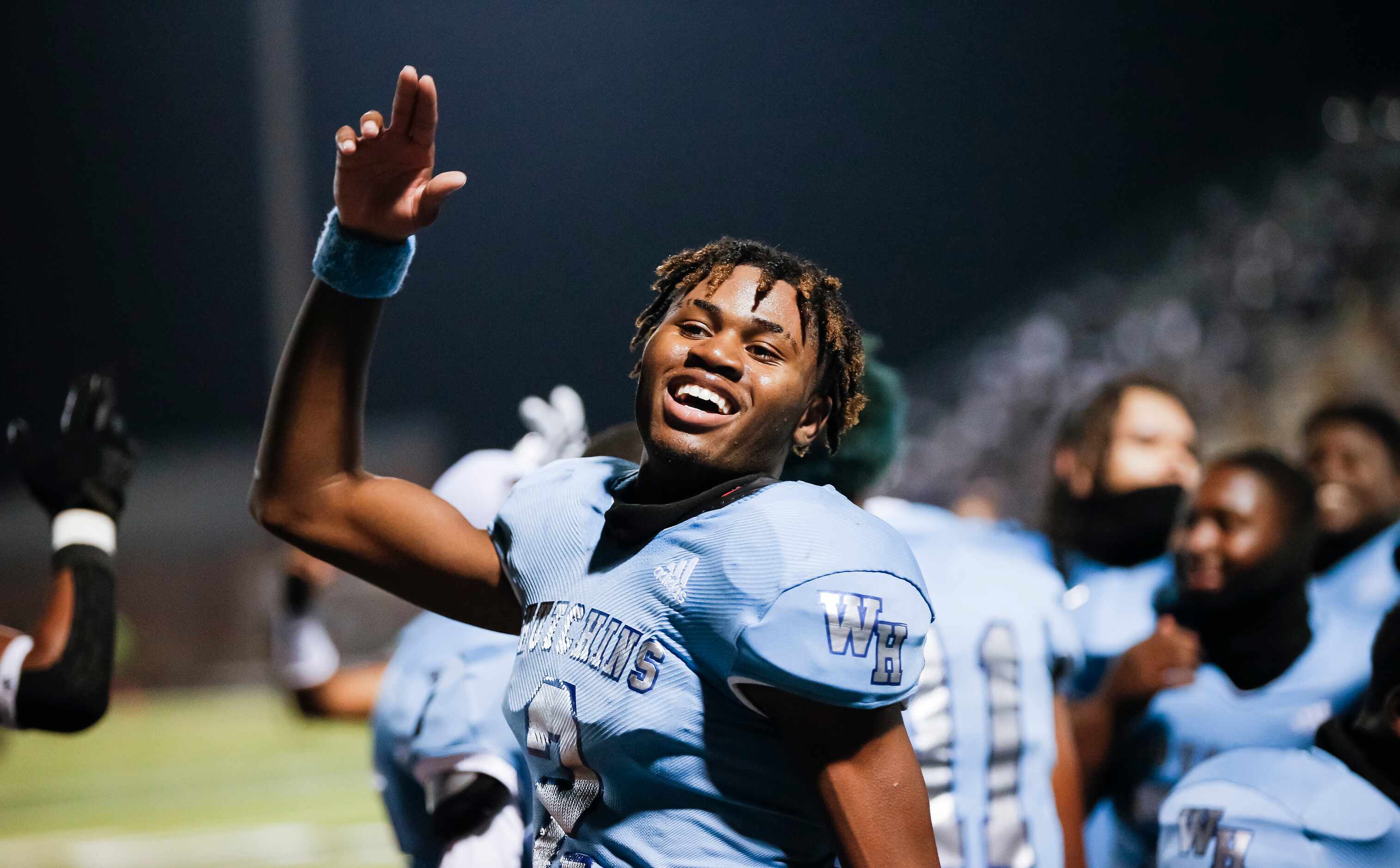 Wilmer-Hutchins senior quarterback Andre Henderson celebrates a 31-28 win over Kaufman after...
