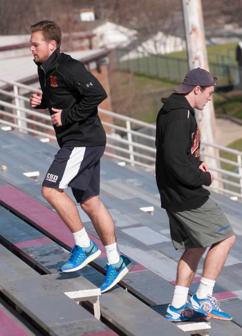 
Travis Wilson (left) and his younger brother, Hayden, run the bleachers at Franklin...